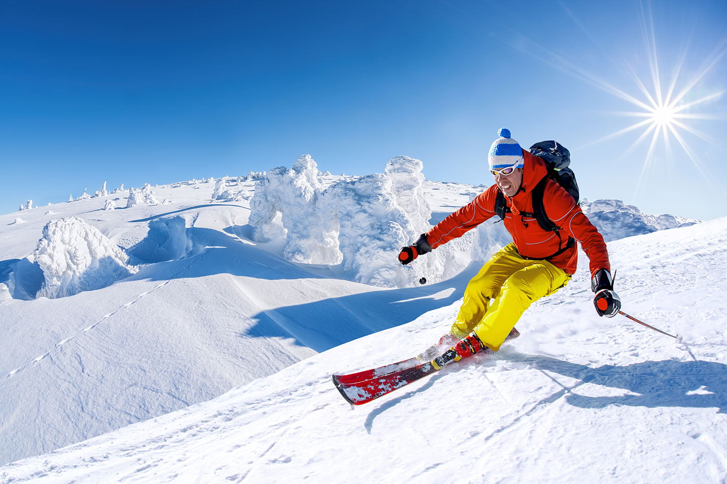 A totally unrelated picture of a man skiing down a mountain really really fast.   He has red skis on, with yellow pants and an orange jacket. He is wearing a blue and white toque with a pom-pom on top. He likely has one of those bitchin' rescue backpacks on that inflate and keep you alive in case there's an avalanche. This kind of experience cost way more than what the boys got for their gems, but I wonder if it involved "snow" in some way...